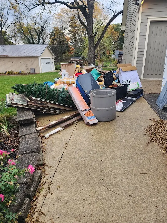 Dumpster being loaded with debris for Roofing Dumpster Rental in Stratford